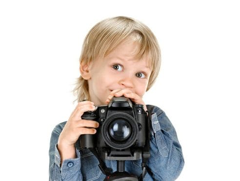child looking over camera