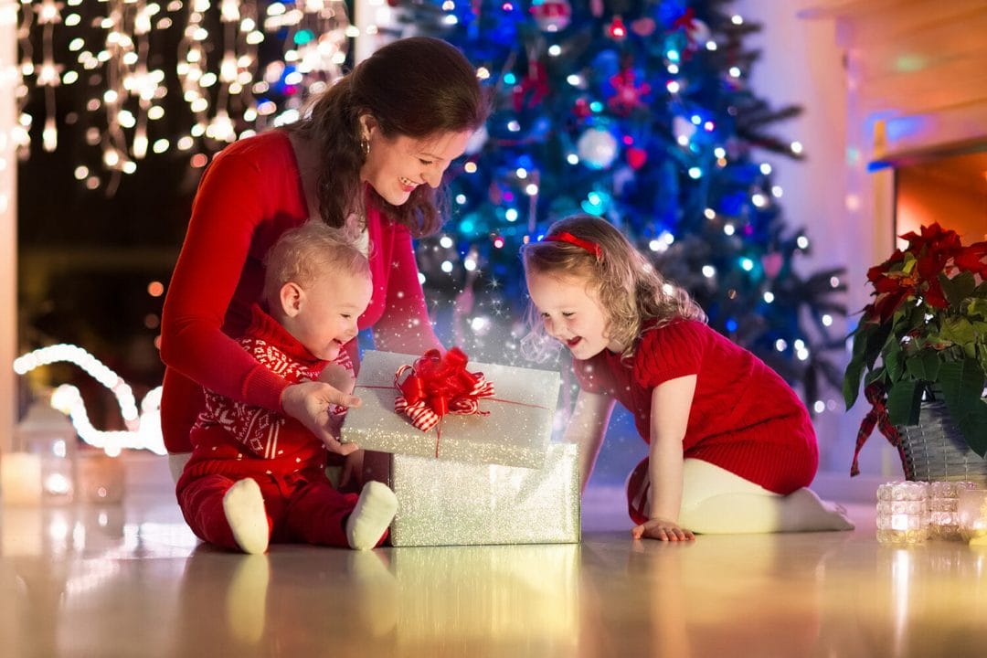 christmas eve parent mother children presents tree lights twinkling
