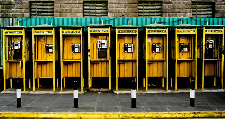yellow phone boxes telephone in a row street photography portrait city people camera subject light how to tutorial guide