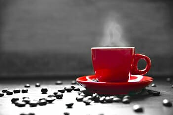 red coffee cup beans black and white hot steam