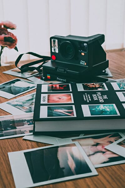 polaroid camera on photo book