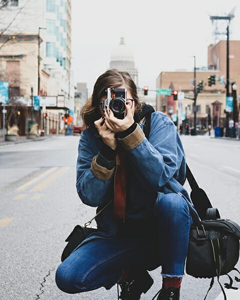 photographer taking picture on street