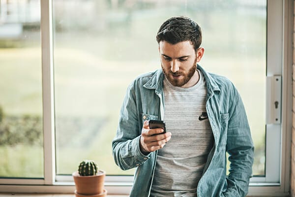 how to pose your friends - man using phone