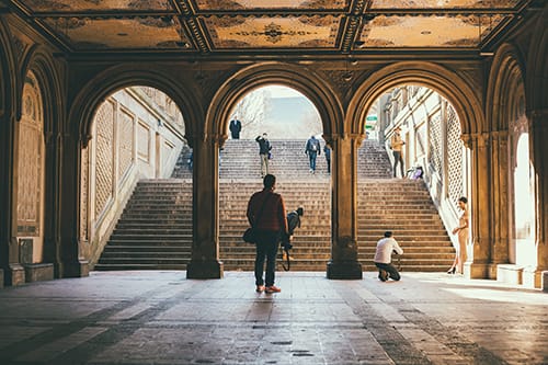 3 arches framing a photographer stairs in the background