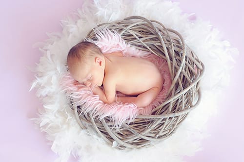 newborn on pink and white background