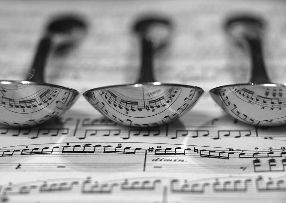 reflections of sheet music on spoons