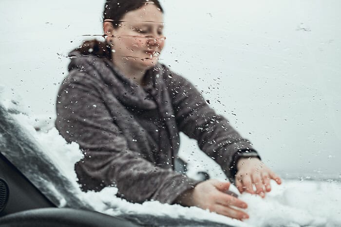 wiping snow off a car expensive camera equipment