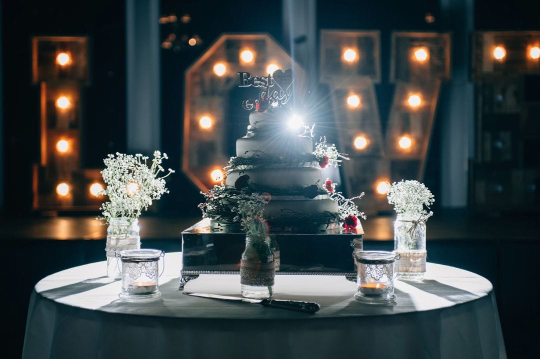 a wedding cake with a lens flare behind it