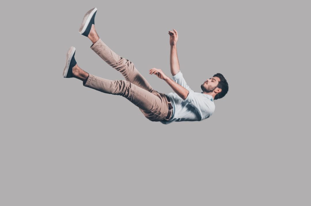 a man falling with his eyes closed