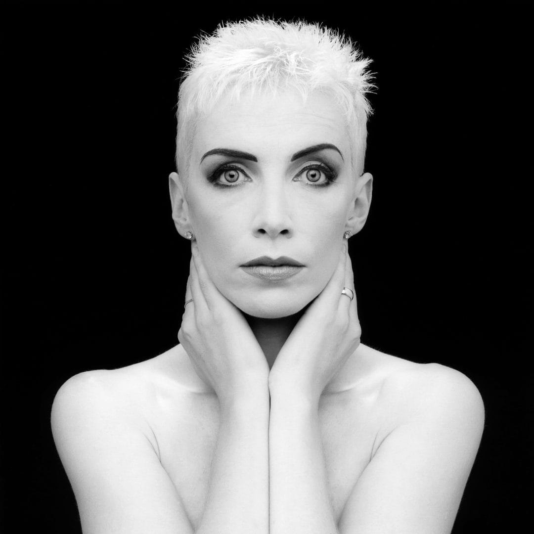 annie lennox touching her face 