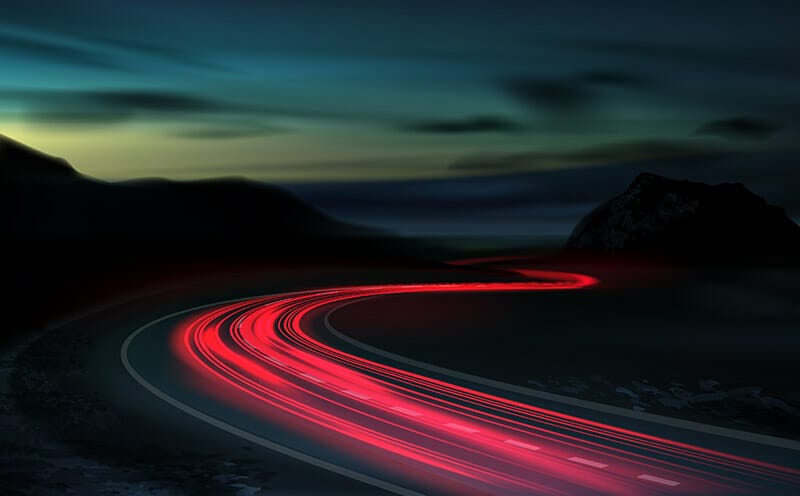 shutter speed red trail light trailing through a countryside road at night