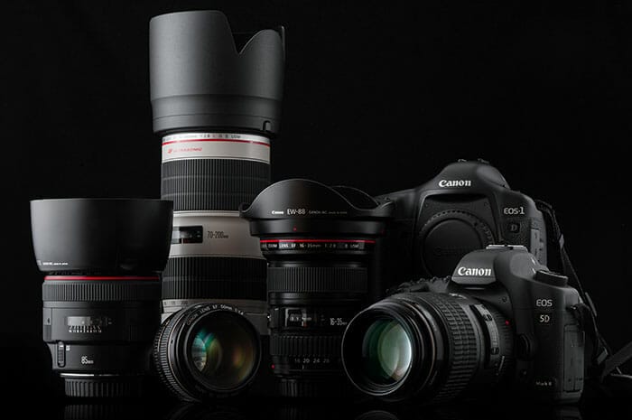 Canon camera and lenses on black background