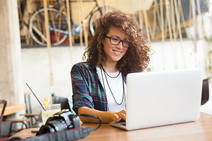 Attractive,Businesswoman,Using,Laptop,At,City,Cafe.,Toothy,Smile. Photography School