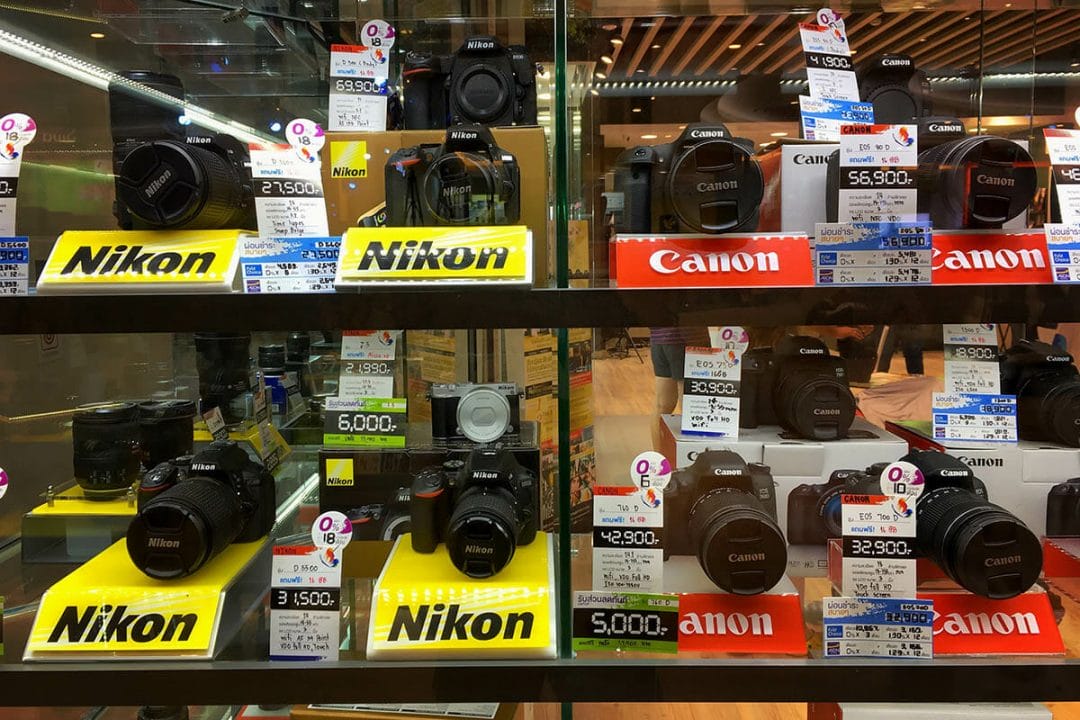 Canon and Nikon cameras in a shop window