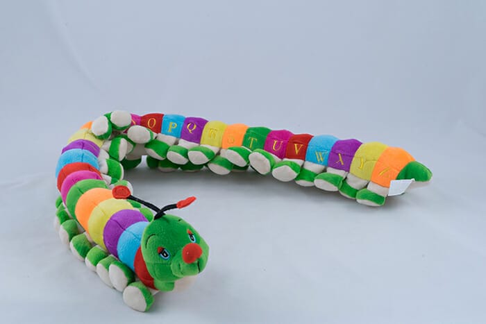Colourful Children's Toy Caterpillar on a grey background