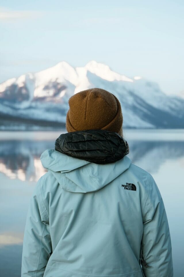 back of a person looking at snowy mountains
