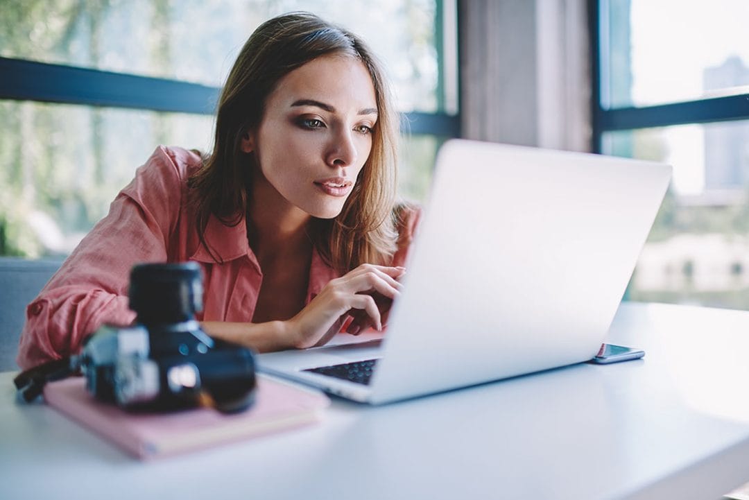 Concentrated,Young,Woman,Watching,Tutorial,Online,On,Modern,Laptop,Device