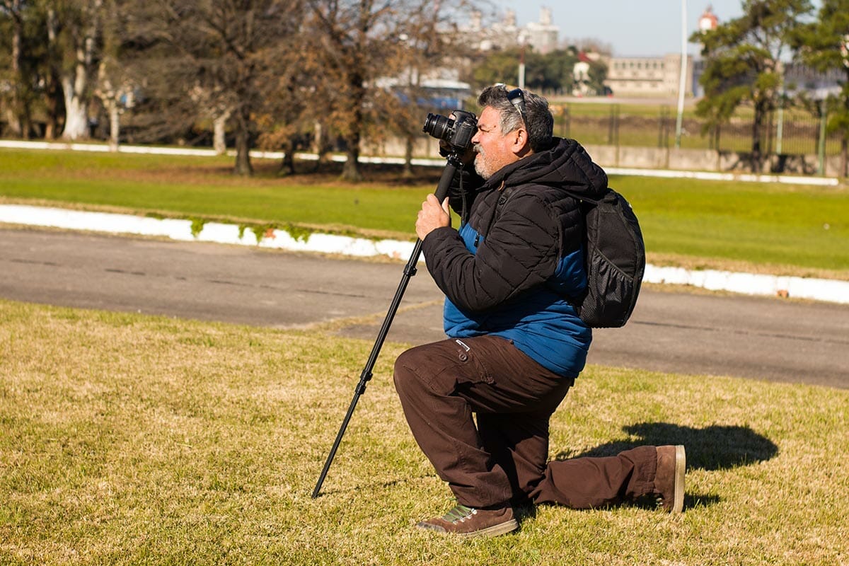 An,Adult,Man,,Crouching,With,A,Camera,Mounted,On,A