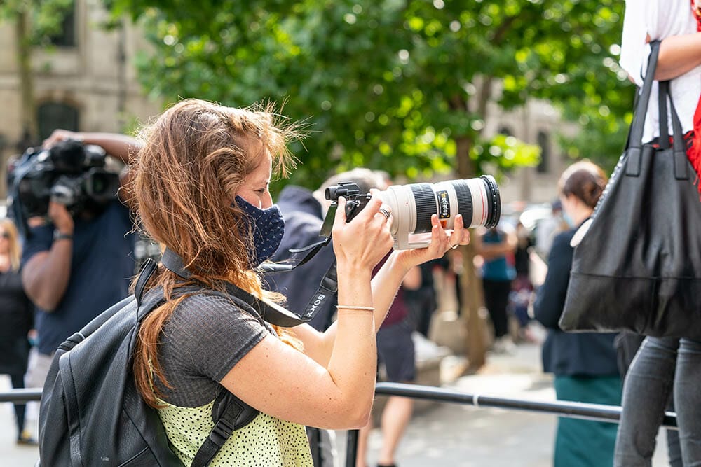 LONDON, ENGLAND - JULY 28, 2020: Freelance female paparazzi photographer outside the entrance to the Royal Courts of Justice, The Strand, London - 604