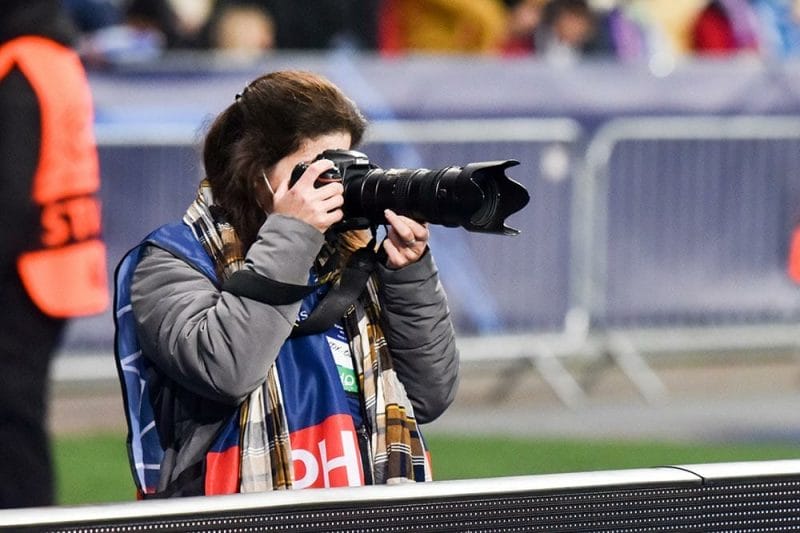 Kyiv, UKRAINE - November 02, 2021: Football photographer with camera during The UEFA Champions League match between Dynamo Kiev (Ukraine) vs FC Barcelona (Spain), Ukraine