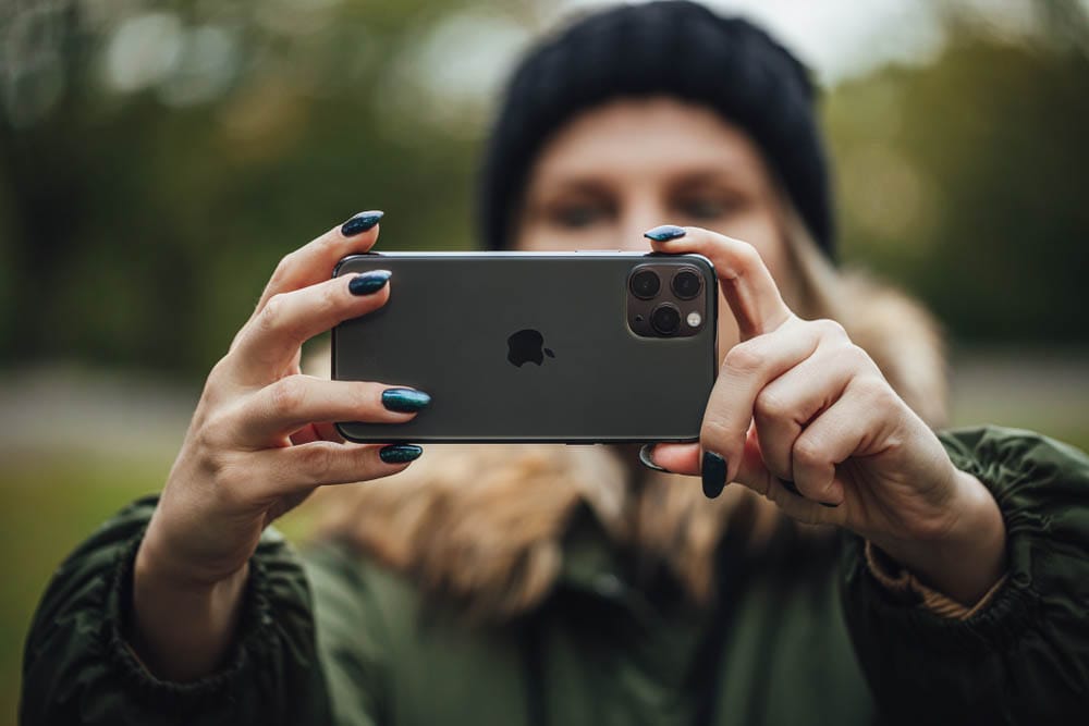 Riga, Latvia September 23.2018 Women Taking Selfies in City Park With new iPhone 11pro smartphone, close up