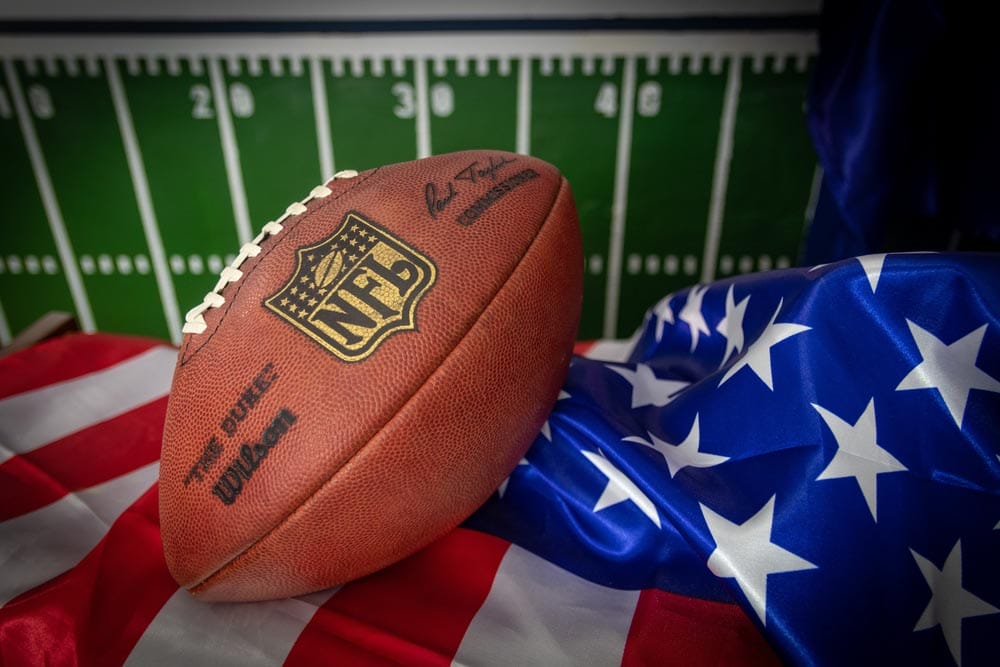 Photoshoot with an NFL ball and an american flag