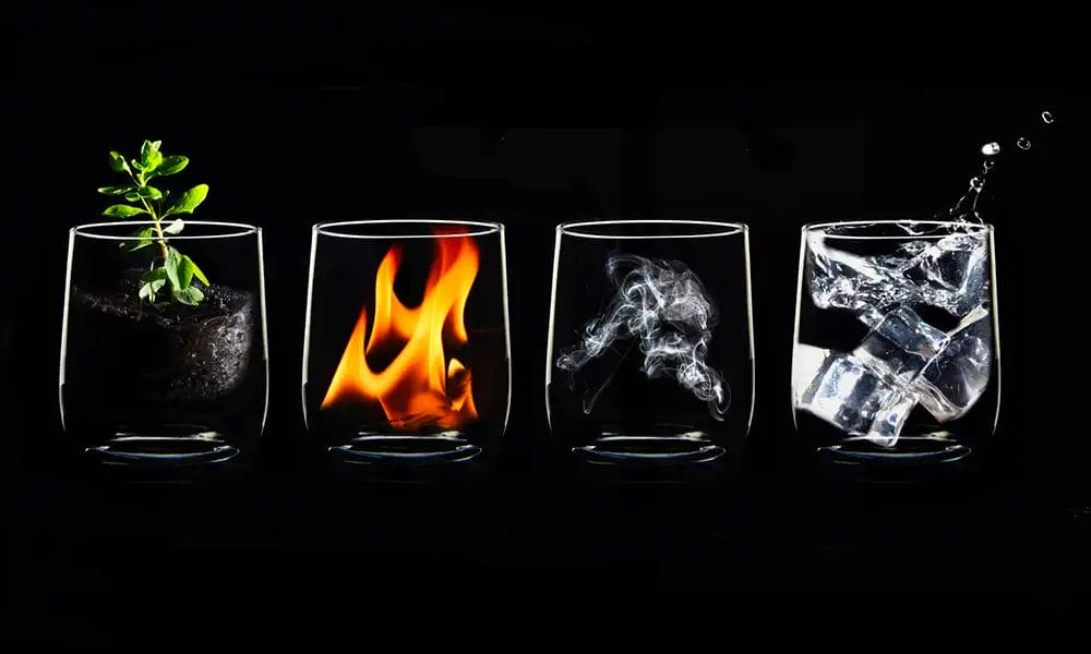 4 glasses with different natural elements inside. Earth, fire, air and water. Copyright Barbara Coulson (iPhotography Student)