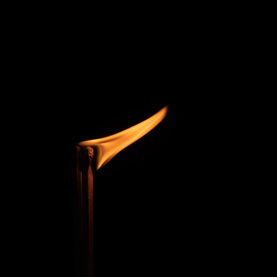 A lit match flame in the dark. Copyright Jo Kayaks (iPhotography Student)