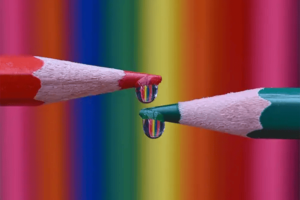 Two pencils with refracted waterdroplets