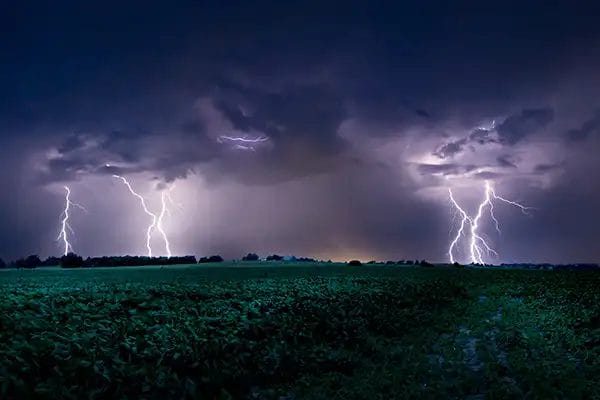 Lightning striking in a storm by Randy Wayman