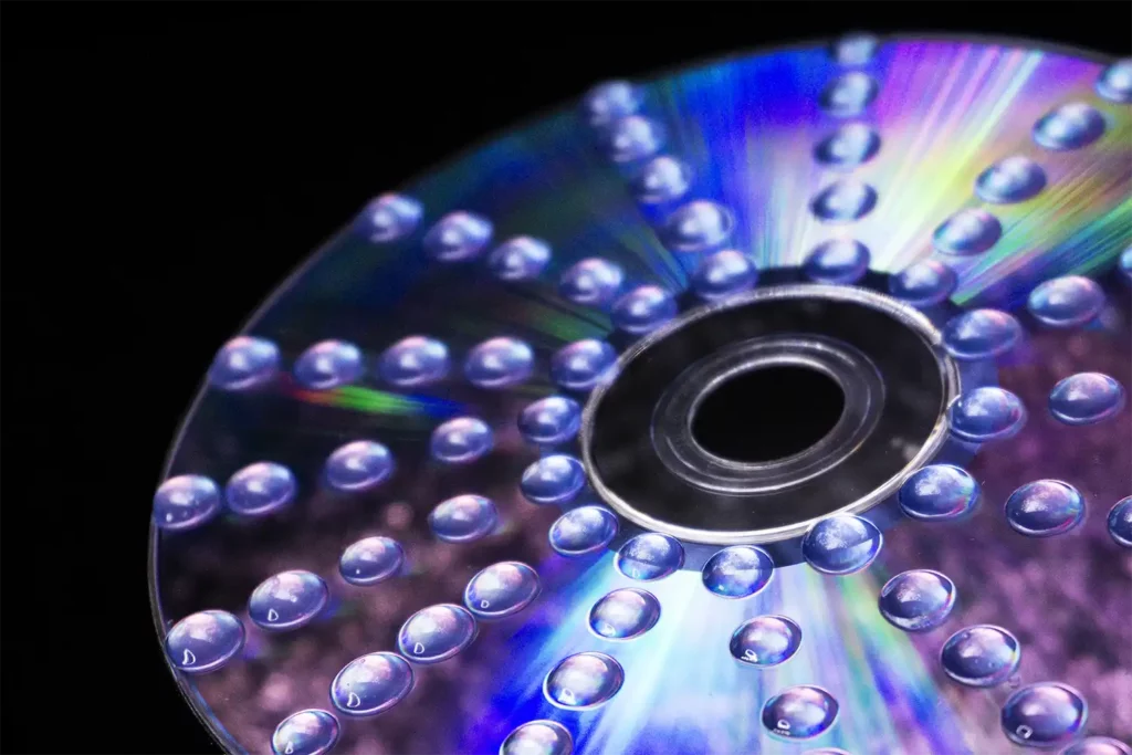 a cd with small water drops on the shiny surface