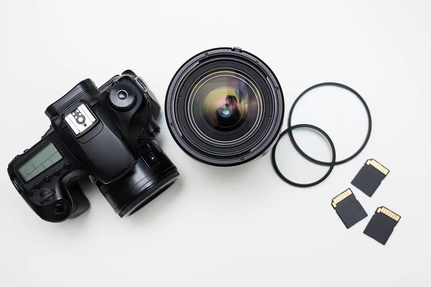 overhead view of camera lens, filters and memory cards